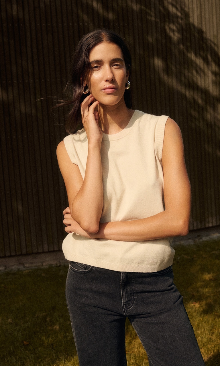 Woman in beige knitted vest