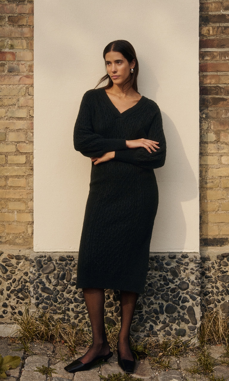 Woman in black knitted dress